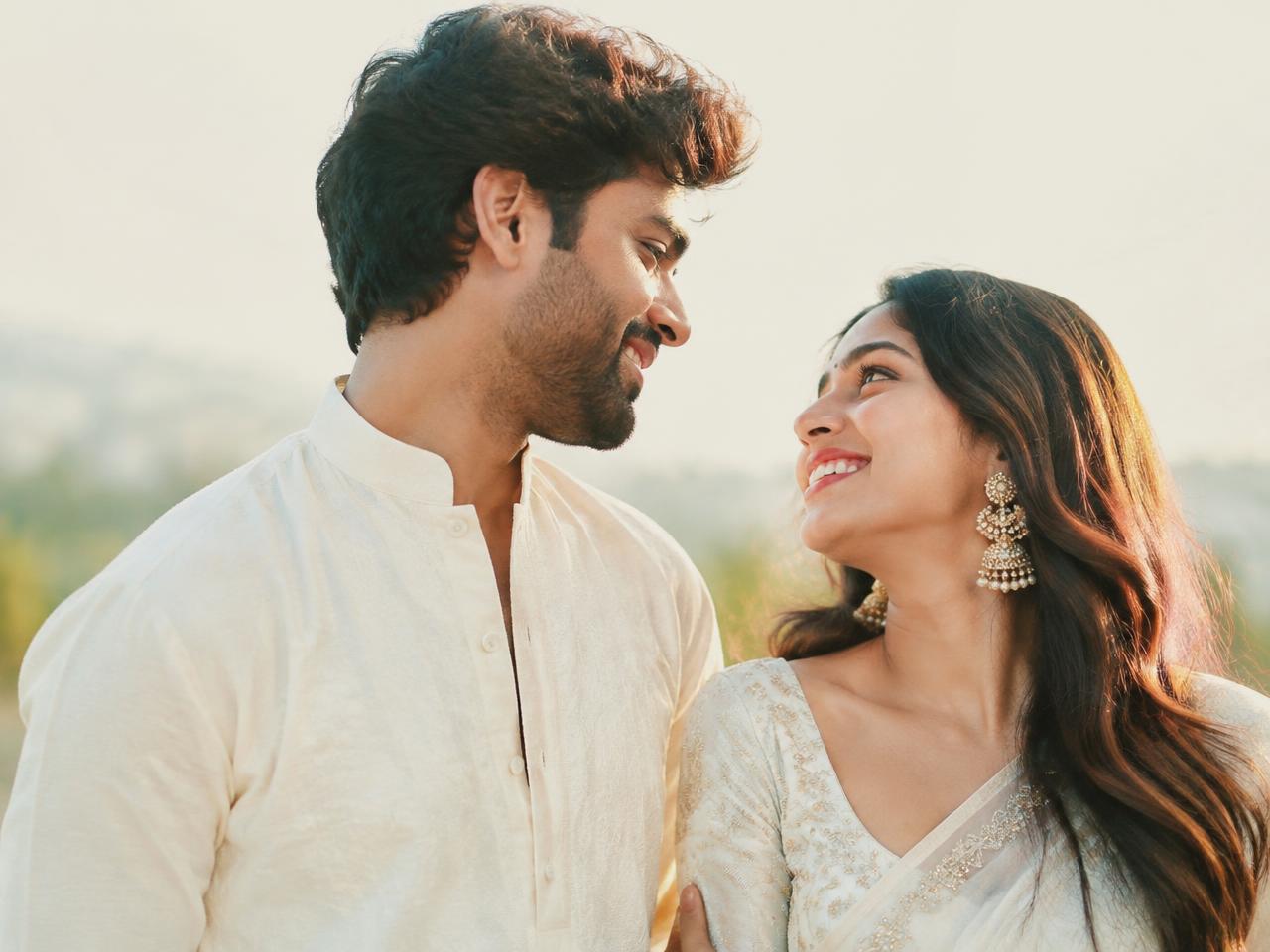 Young Indian couple smiling at each other in soft sunlight